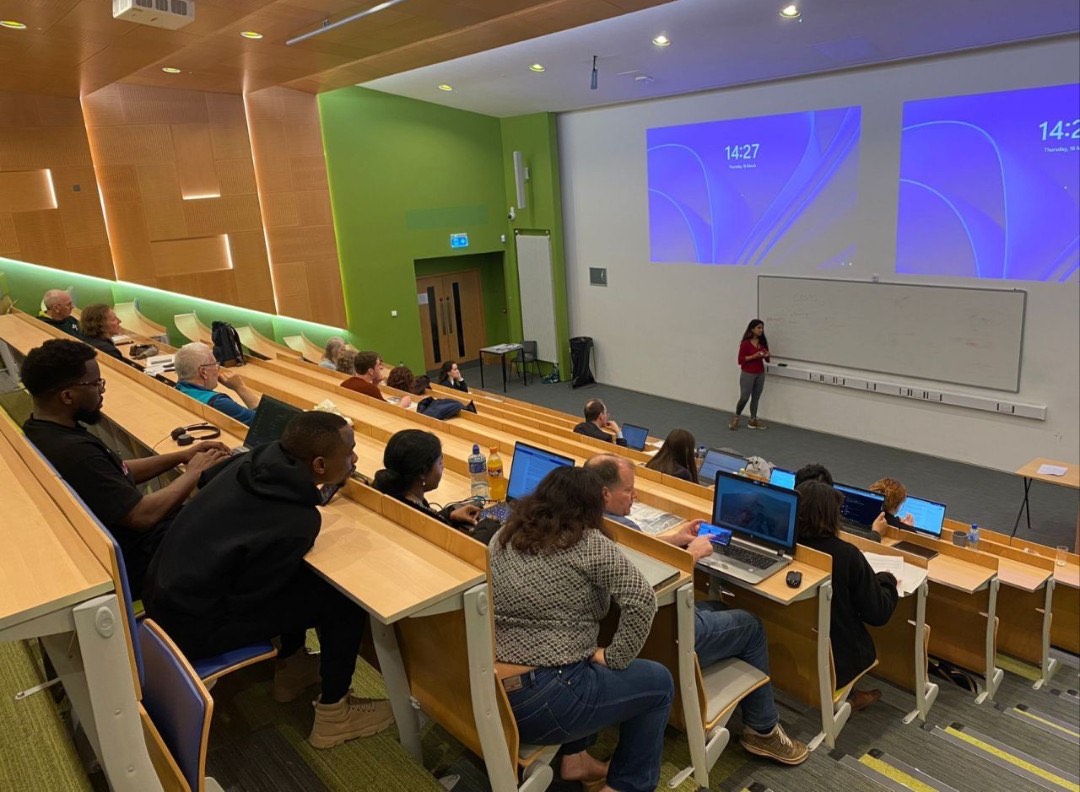 Ananya Tiwari teaching in a lecture hall with a green wall at ATU Sligo