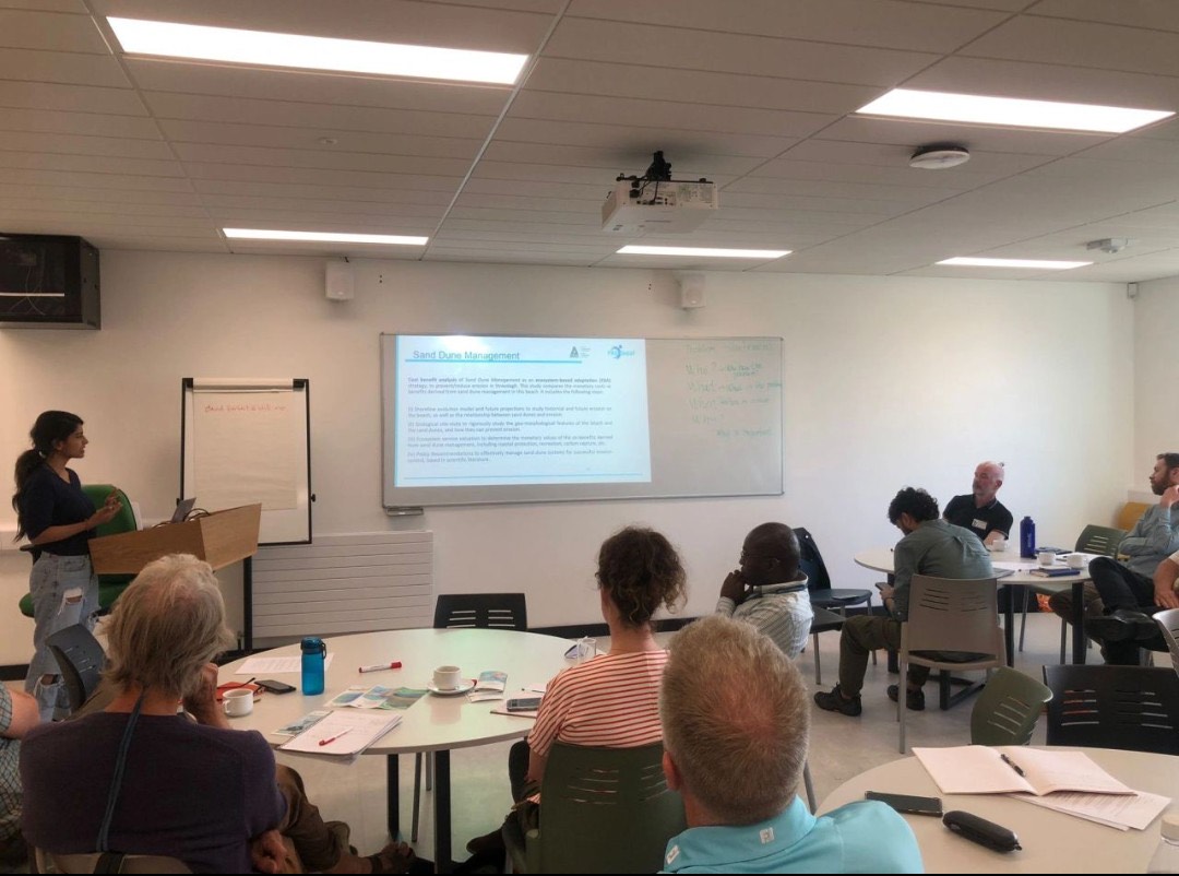 Ananya Tiwari presenting dune management research to a seated workshop audience